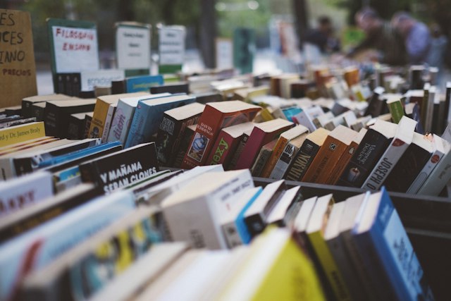 A stack of photo books and magazines on display