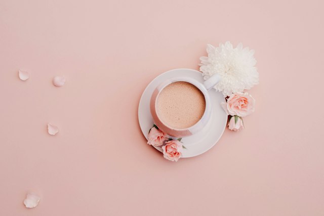 A coffee on a saucer with flowers — the morning-coffee-across-time-zones ritual
